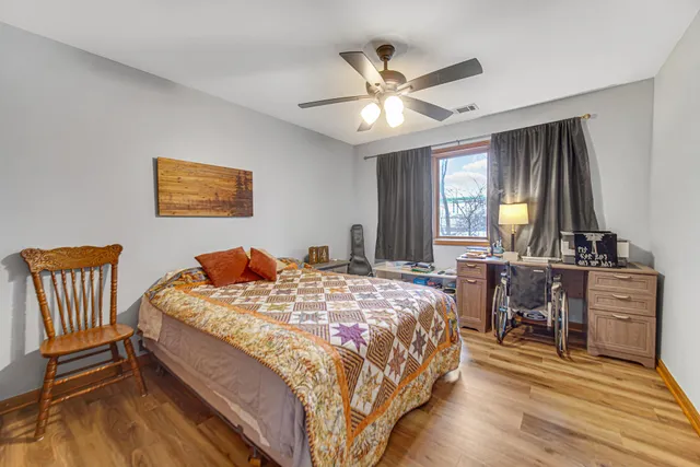 a bedroom with a bed and a chandelier