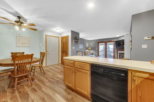 a kitchen with a sink cabinets and wooden floor