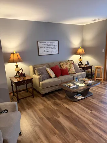 a living room with furniture and a lamp