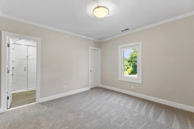 an empty room with windows and closet