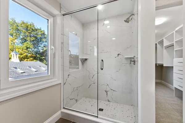 a bathroom with a glass shower door