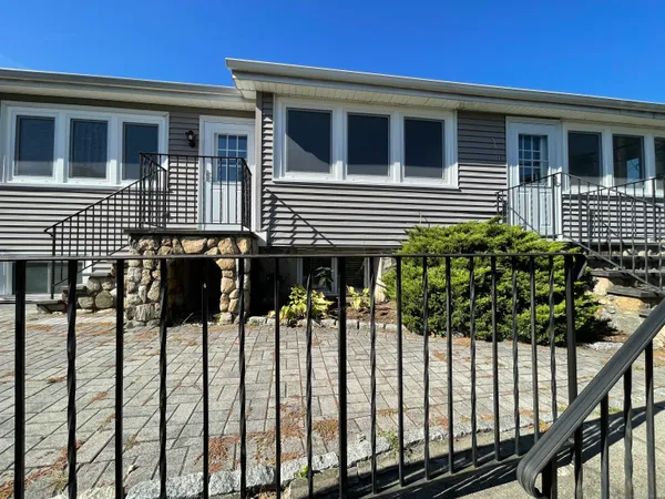 a view of a house with wooden fence