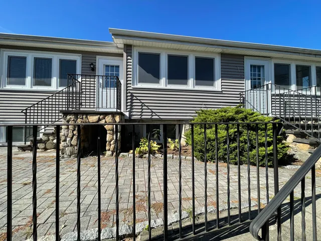 a view of a house with wooden fence