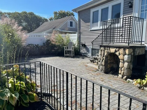 a view of a house with backyard and sitting area