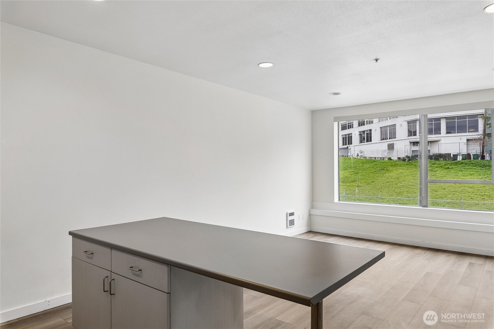 66 Bell Street, Unit 23 Seattle, WA 98121 - Photo 11 of 24 an empty room with a window and outer view