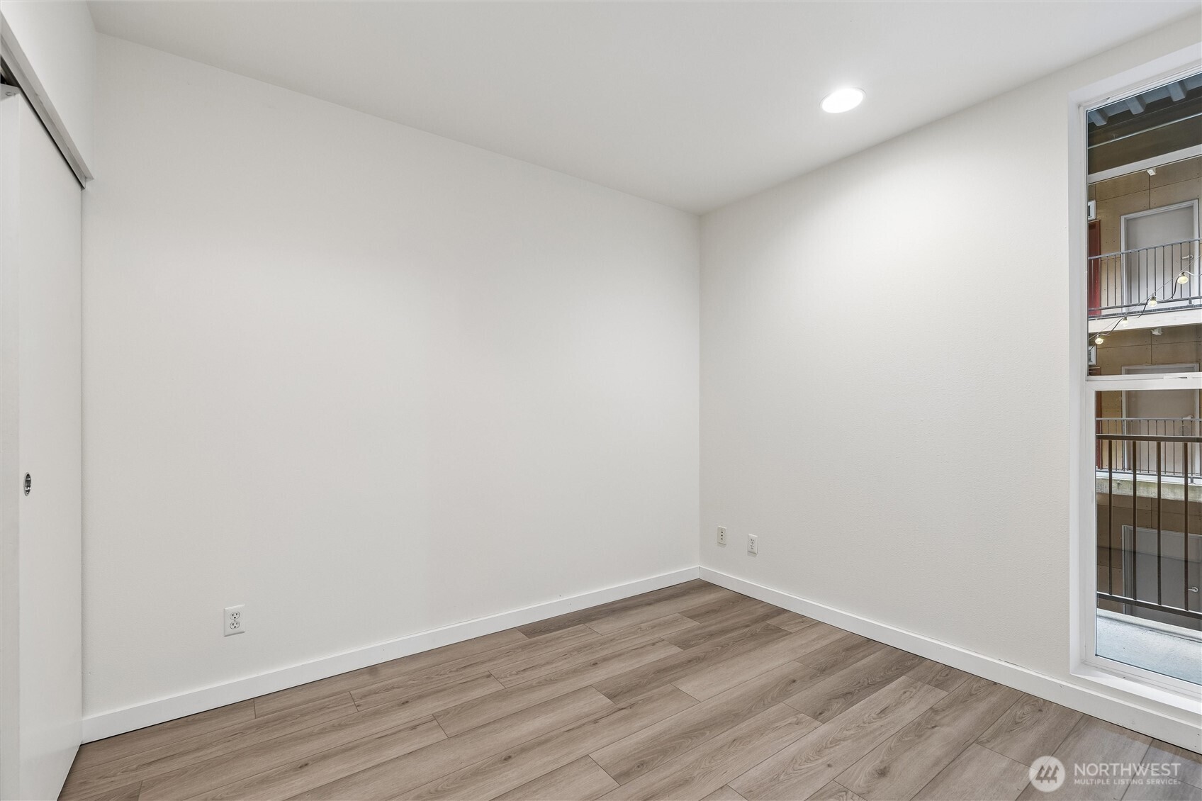 66 Bell Street, Unit 23 Seattle, WA 98121 - Photo 20 of 24 a view of empty room with wooden floor and fan