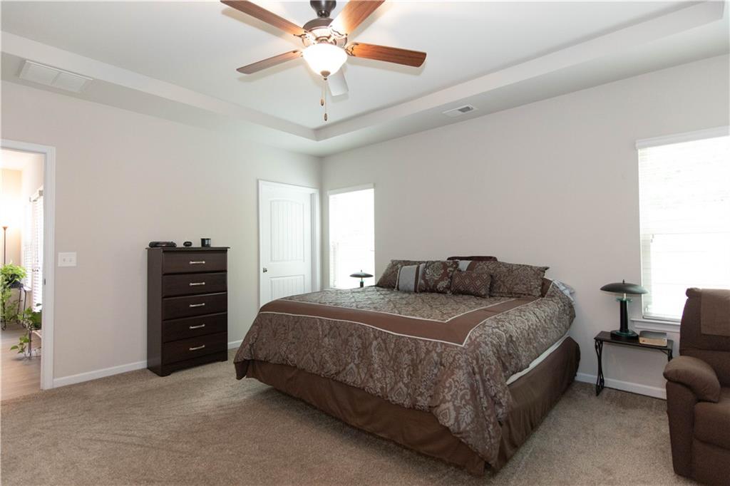 103 Prominence Court Canton, GA 30114 - Photo 17 of 34 a bedroom with a bed and a chandelier