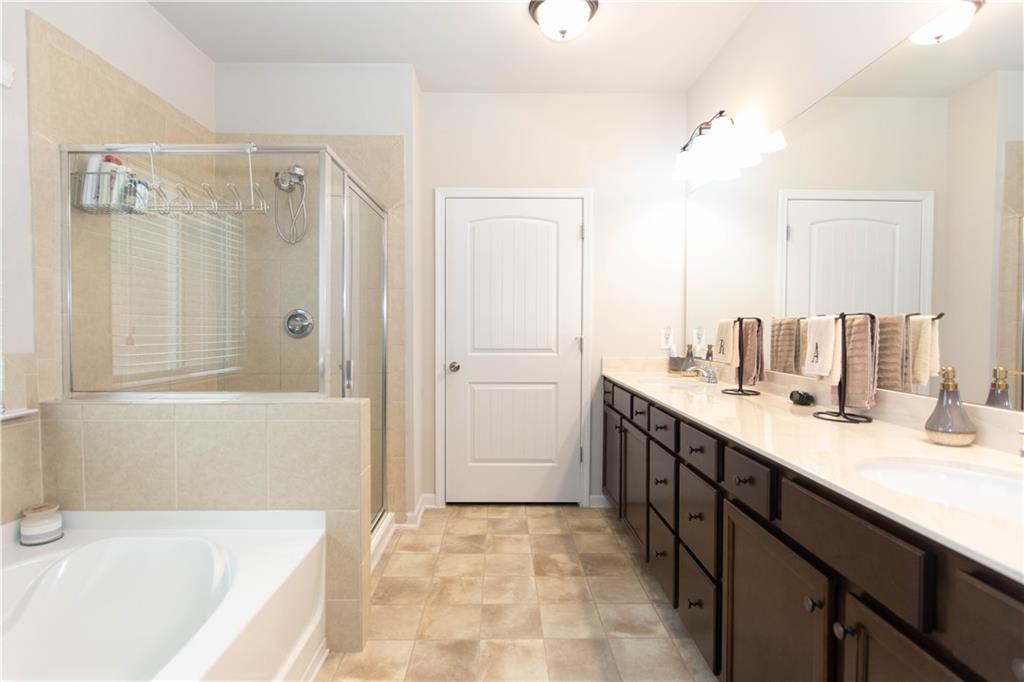 103 Prominence Court Canton, GA 30114 - Photo 18 of 34 a spacious bathroom with a tub sink and mirror