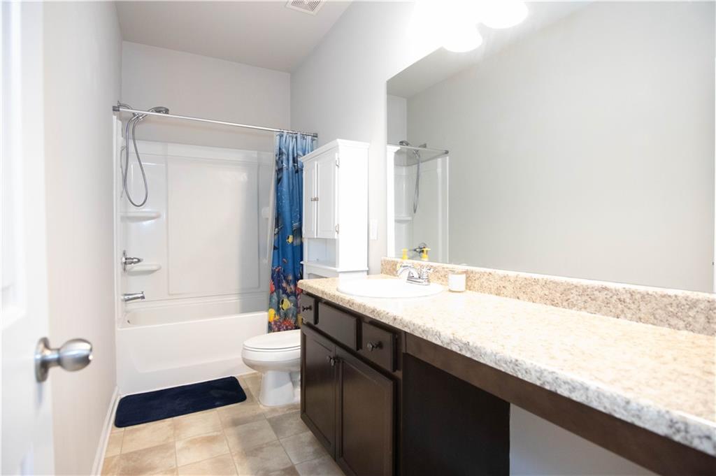 103 Prominence Court Canton, GA 30114 - Photo 20 of 34 a bathroom with a granite countertop sink a toilet and shower