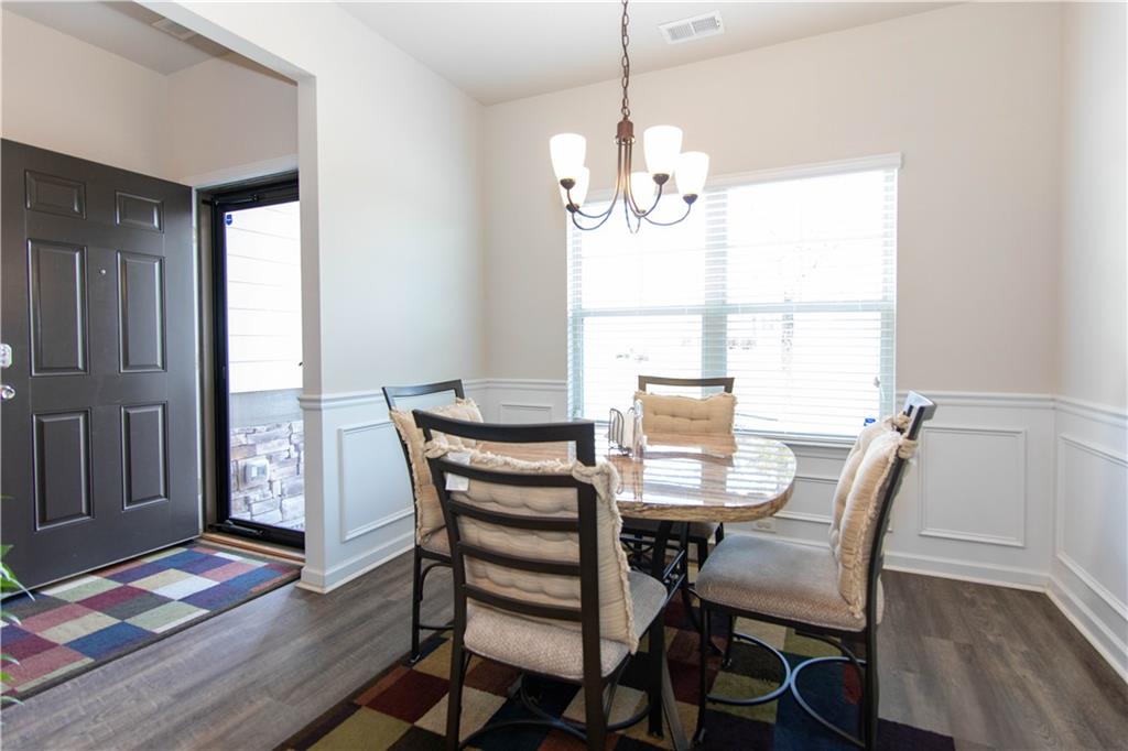 103 Prominence Court Canton, GA 30114 - Photo 2 of 34 a view of a dining room with furniture wooden floor and chandelier