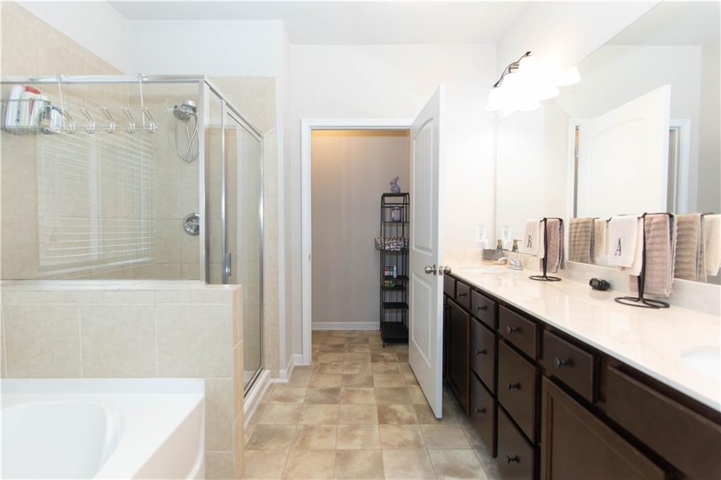 103 Prominence Court Canton, GA 30114 - Photo 22 of 34 a spacious bathroom with a shower sink and mirror