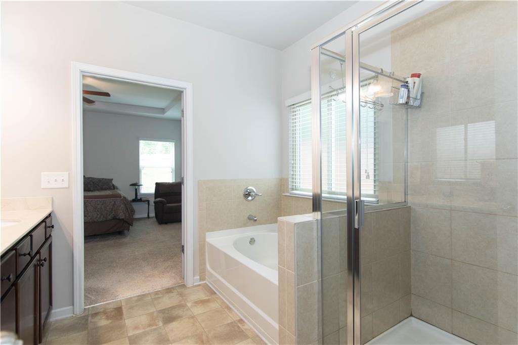 103 Prominence Court Canton, GA 30114 - Photo 24 of 34 a bathroom with a bathtub and a shower