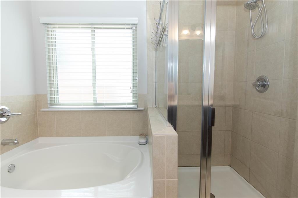 103 Prominence Court Canton, GA 30114 - Photo 25 of 34 a white bath tub sitting next to a shower