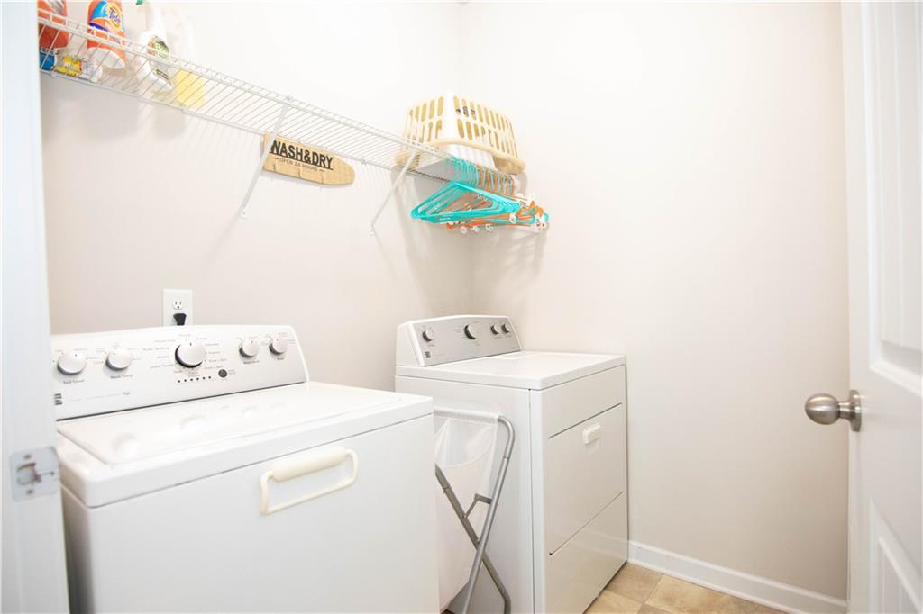 103 Prominence Court Canton, GA 30114 - Photo 26 of 34 a utility room with dryer and washer