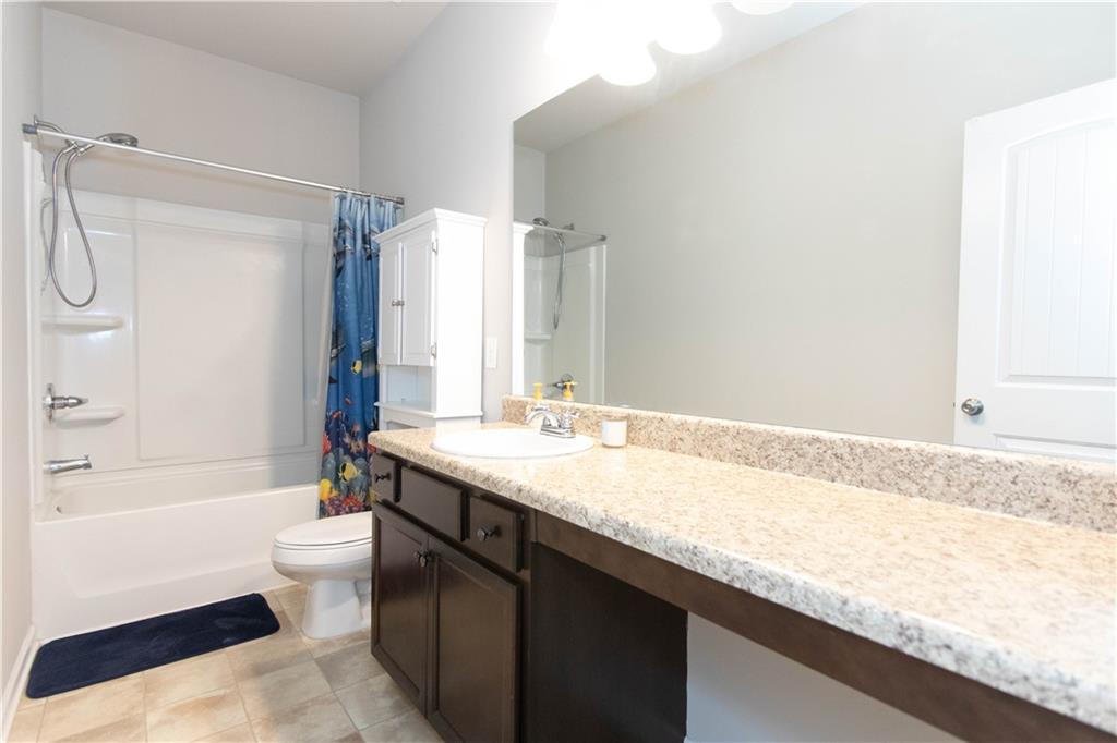 103 Prominence Court Canton, GA 30114 - Photo 28 of 34 a bathroom with a granite countertop bathtub sink vanity mirror and toilet