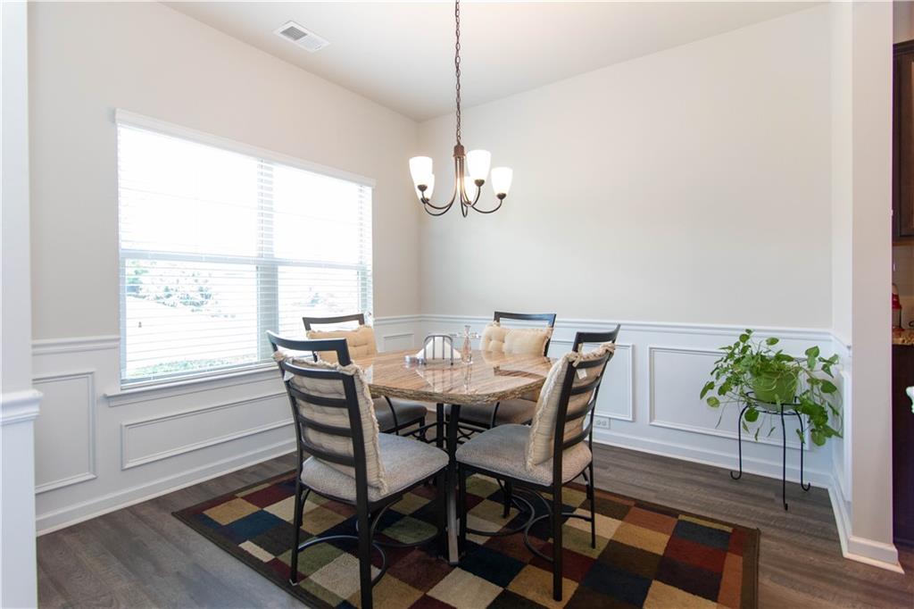 103 Prominence Court Canton, GA 30114 - Photo 3 of 34 a view of a dining room with furniture window and wooden floor