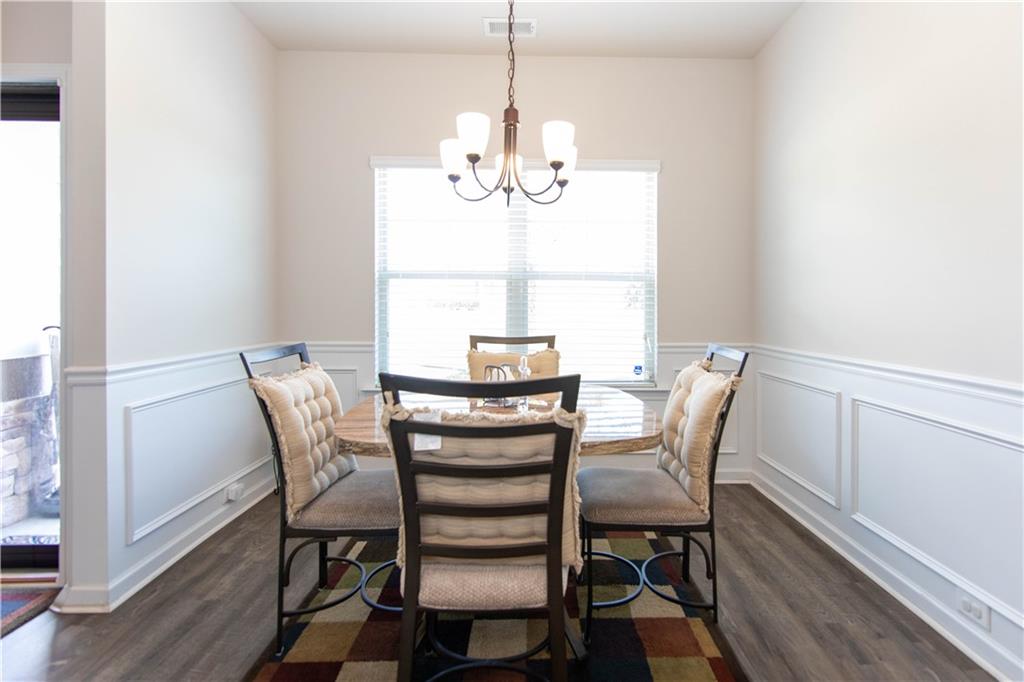 103 Prominence Court Canton, GA 30114 - Photo 4 of 34 a view of a dining room with furniture a chandelier and wooden floor