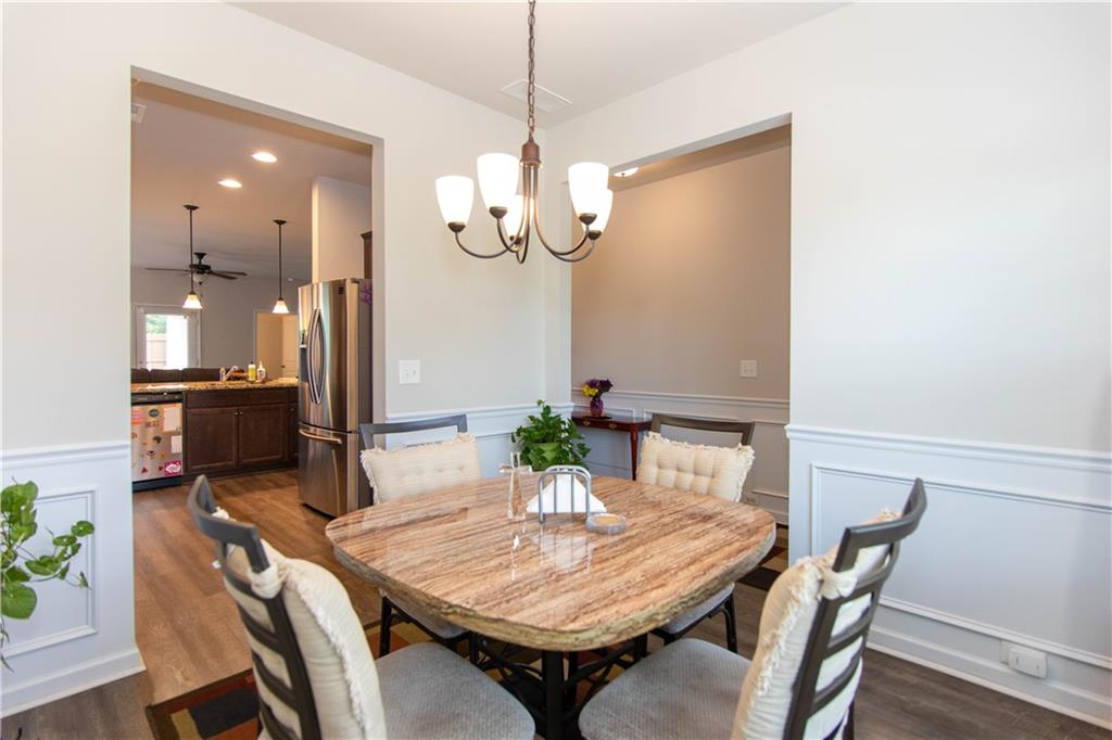 103 Prominence Court Canton, GA 30114 - Photo 5 of 34 a view of a dining room with furniture a chandelier and wooden floor