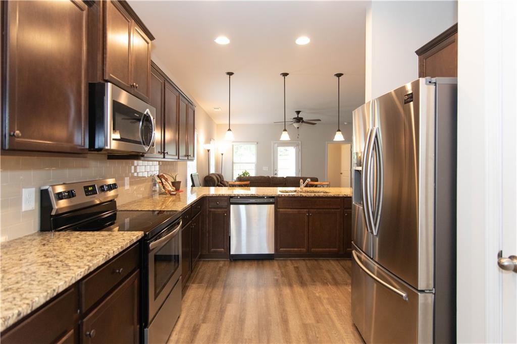 103 Prominence Court Canton, GA 30114 - Photo 9 of 34 a kitchen with stainless steel appliances granite countertop a refrigerator a stove a sink and a microwave