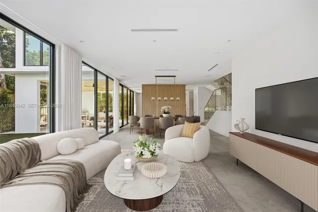 a living room with furniture and a potted plant