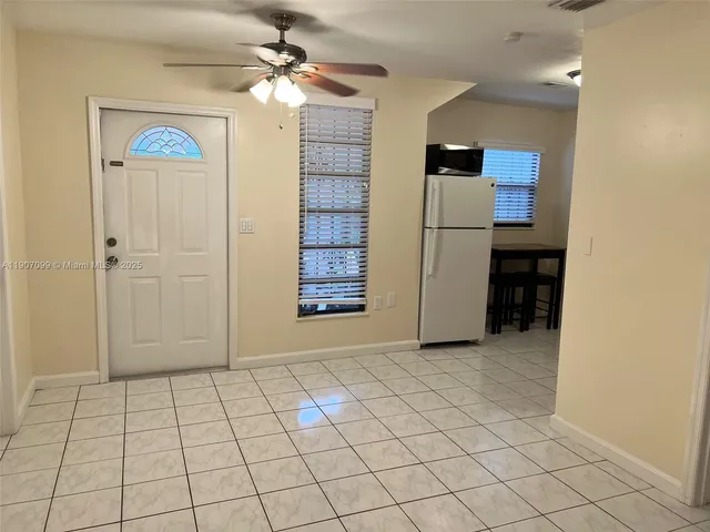 an empty room with closet and windows
