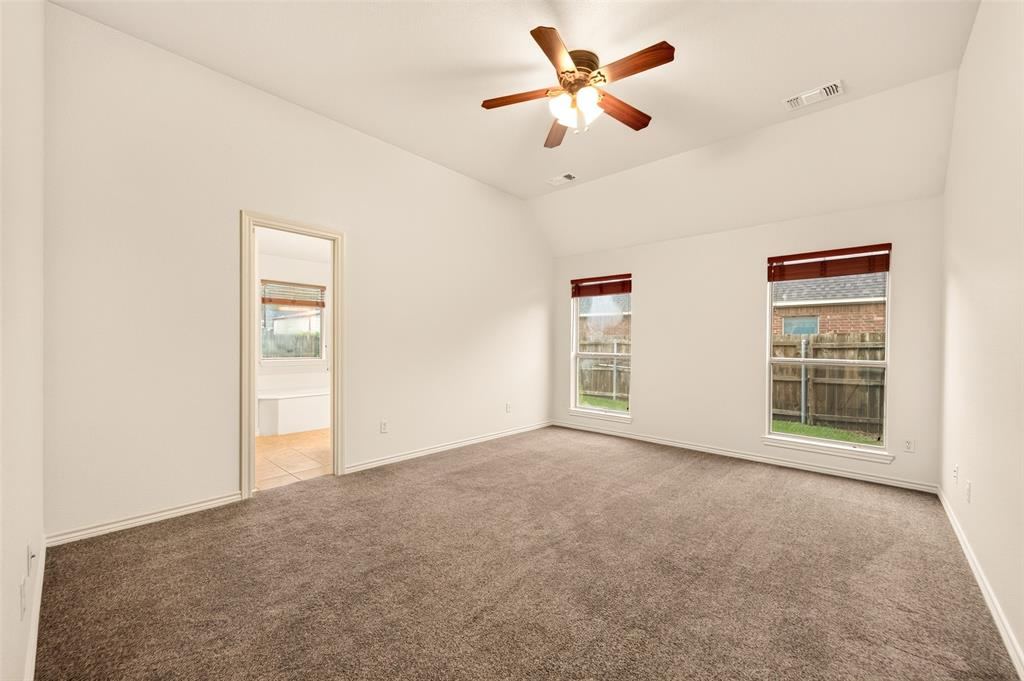 2105 Ridgewood Drive Bridgeport, TX 76426 - Photo 17 of 27 Grey carpeted primary bedroom with vaulted ceilings