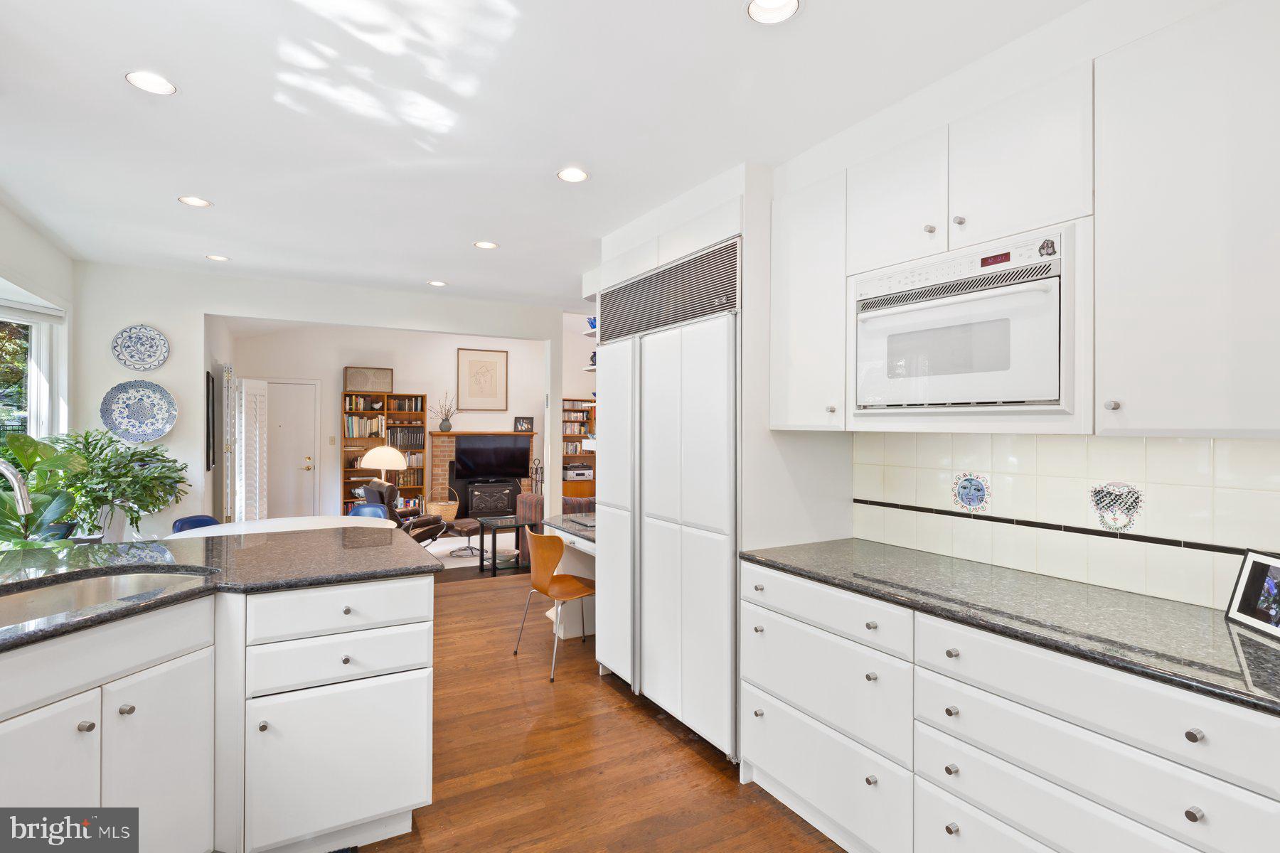 16400 Montecrest Lane Gaithersburg, MD 20878 - Photo 17 of 58 a kitchen with granite countertop white cabinets and white appliances