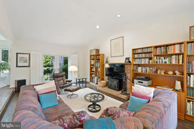 a living room with furniture and a book shelf