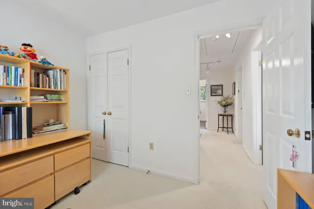 a living room with furniture and a book shelf