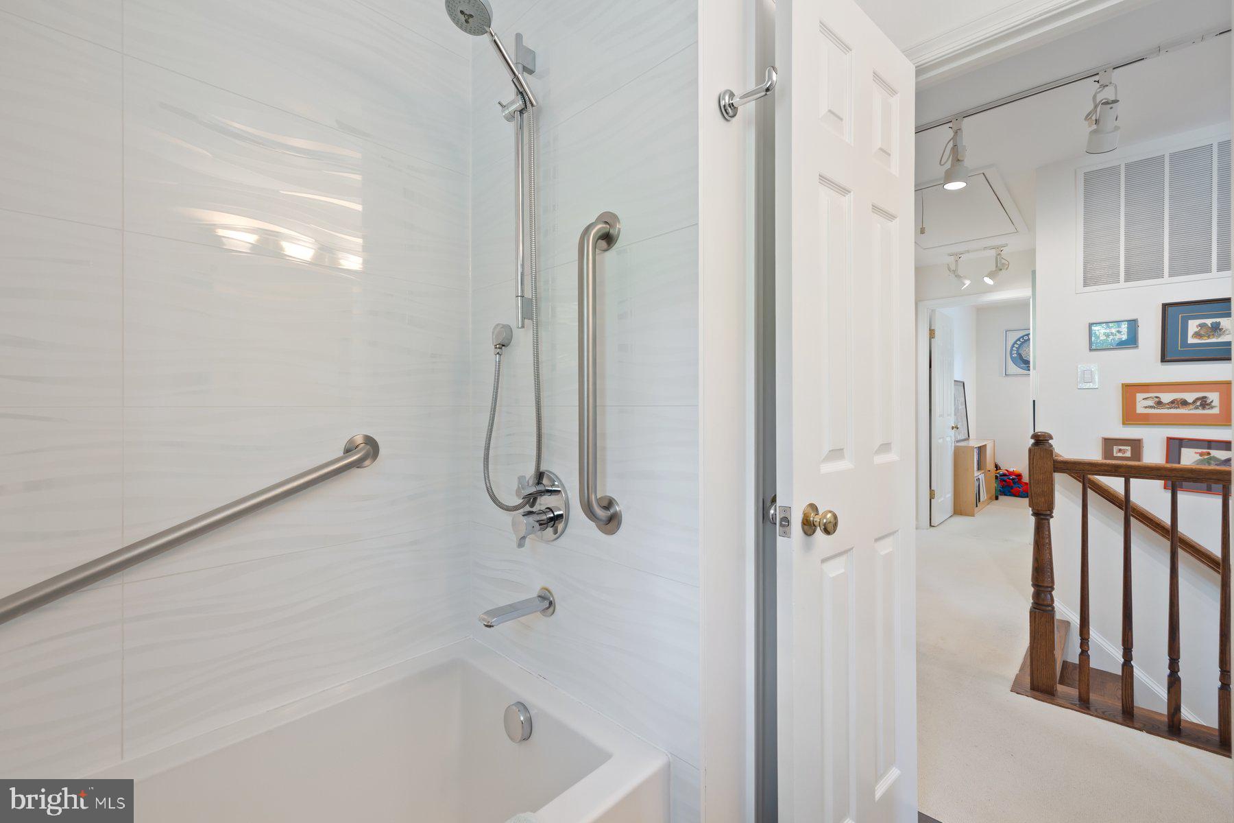16400 Montecrest Lane Gaithersburg, MD 20878 - Photo 35 of 58 a bathroom with a tub a mirror and a shower