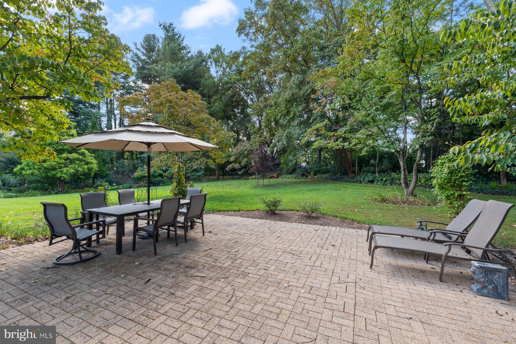 16400 Montecrest Lane Gaithersburg, MD 20878 - Photo 46 of 58 a view of a outdoor with a table and chairs under an umbrella