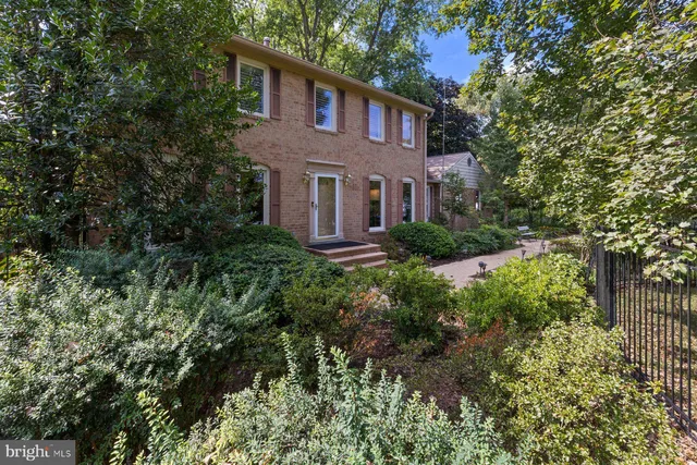 a living room with furniture and a dining table with rug