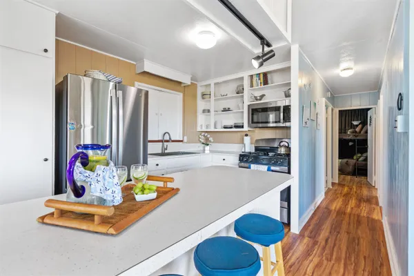 a kitchen with stainless steel appliances granite countertop a sink and cabinets