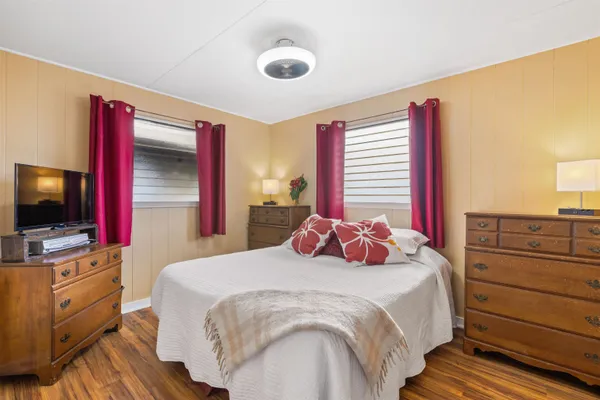 a bedroom with a bed and a flat screen tv