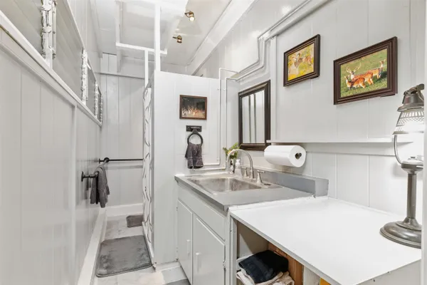 a bathroom with a sink a mirror and a toilet
