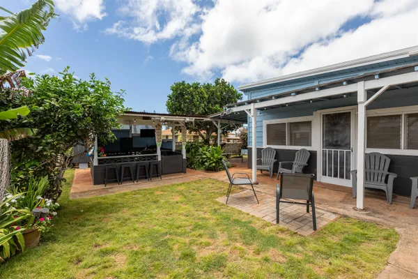 a swimming pool with outdoor seating and yard