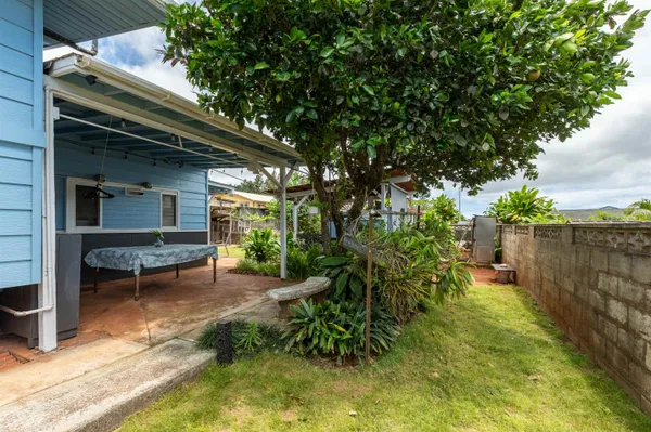 a backyard of a house with table and chairs