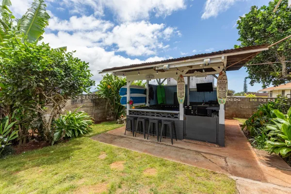 a view of a backyard with seating area