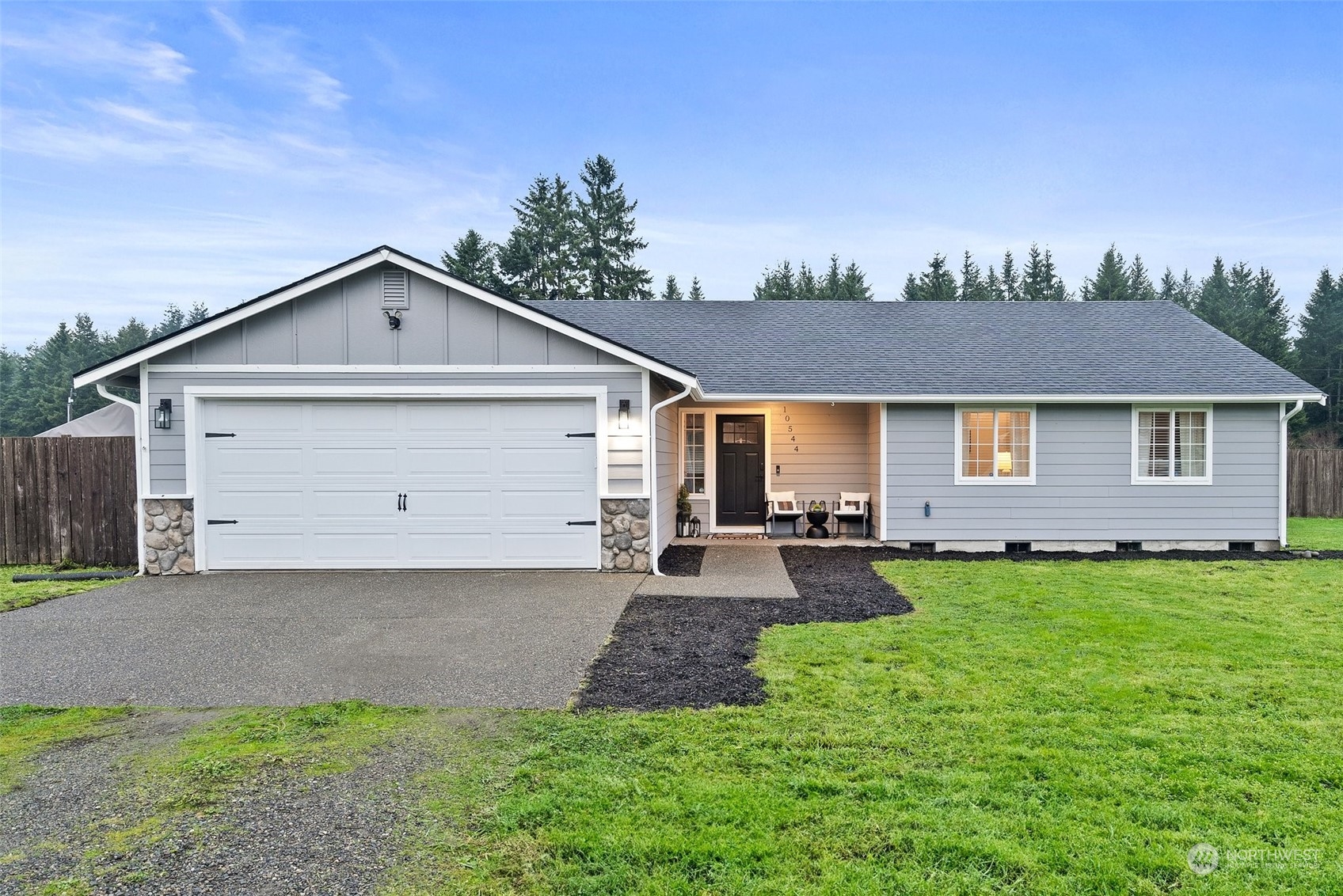10544 School Land Road Southwest Rochester, WA 98579 - Photo 1 of 28 a front view of a house with a yard and garage