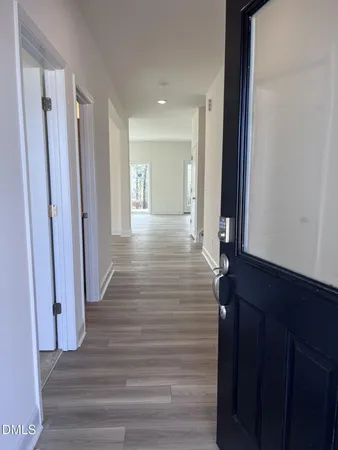 a view of a hallway with wooden floor and staircase