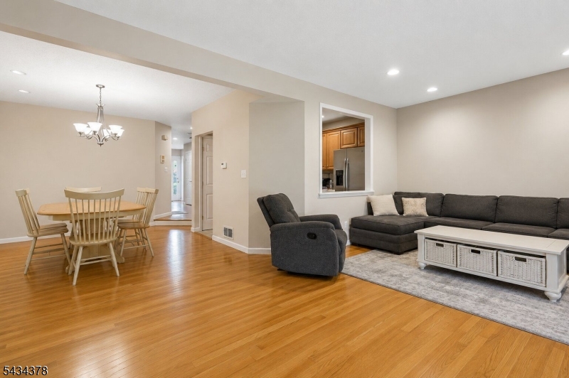 606 Park Place Springfield, NJ 07081 - Photo 6 of 21 a living room with furniture and a chandelier