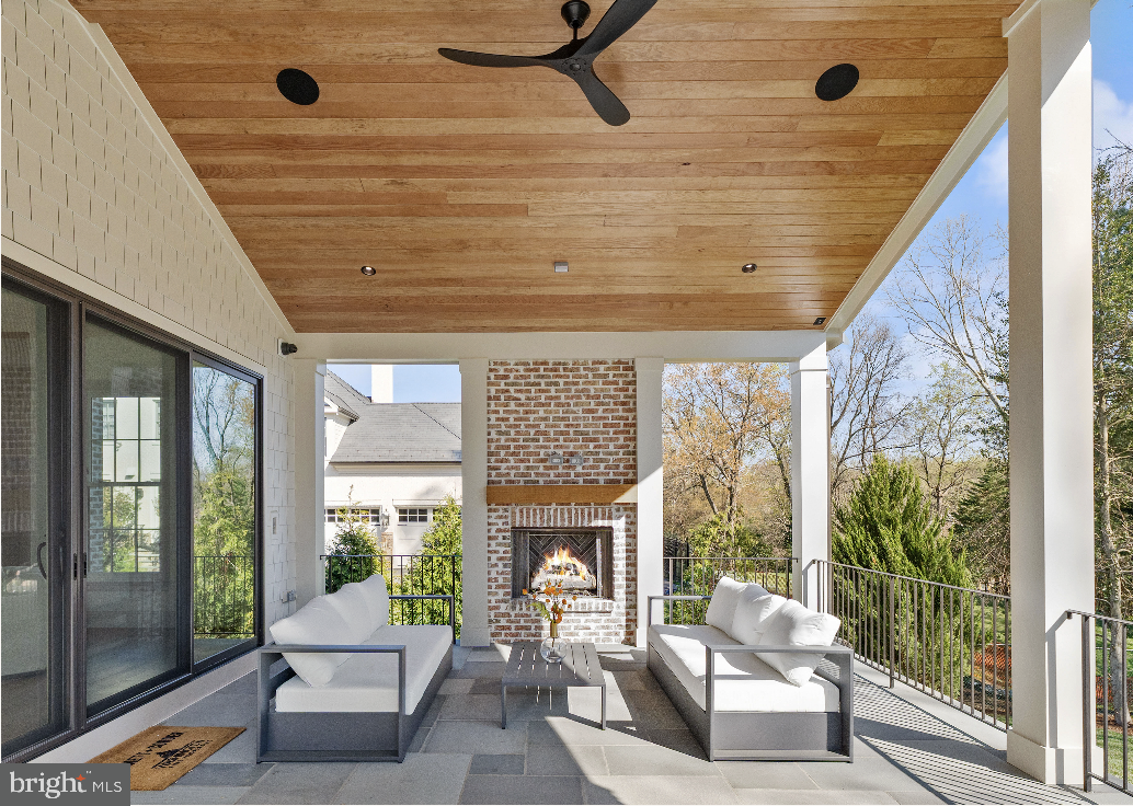 6913 Benjamin Street McLean, VA 22101 - Photo 15 of 51 a living room with patio furniture and a fireplace