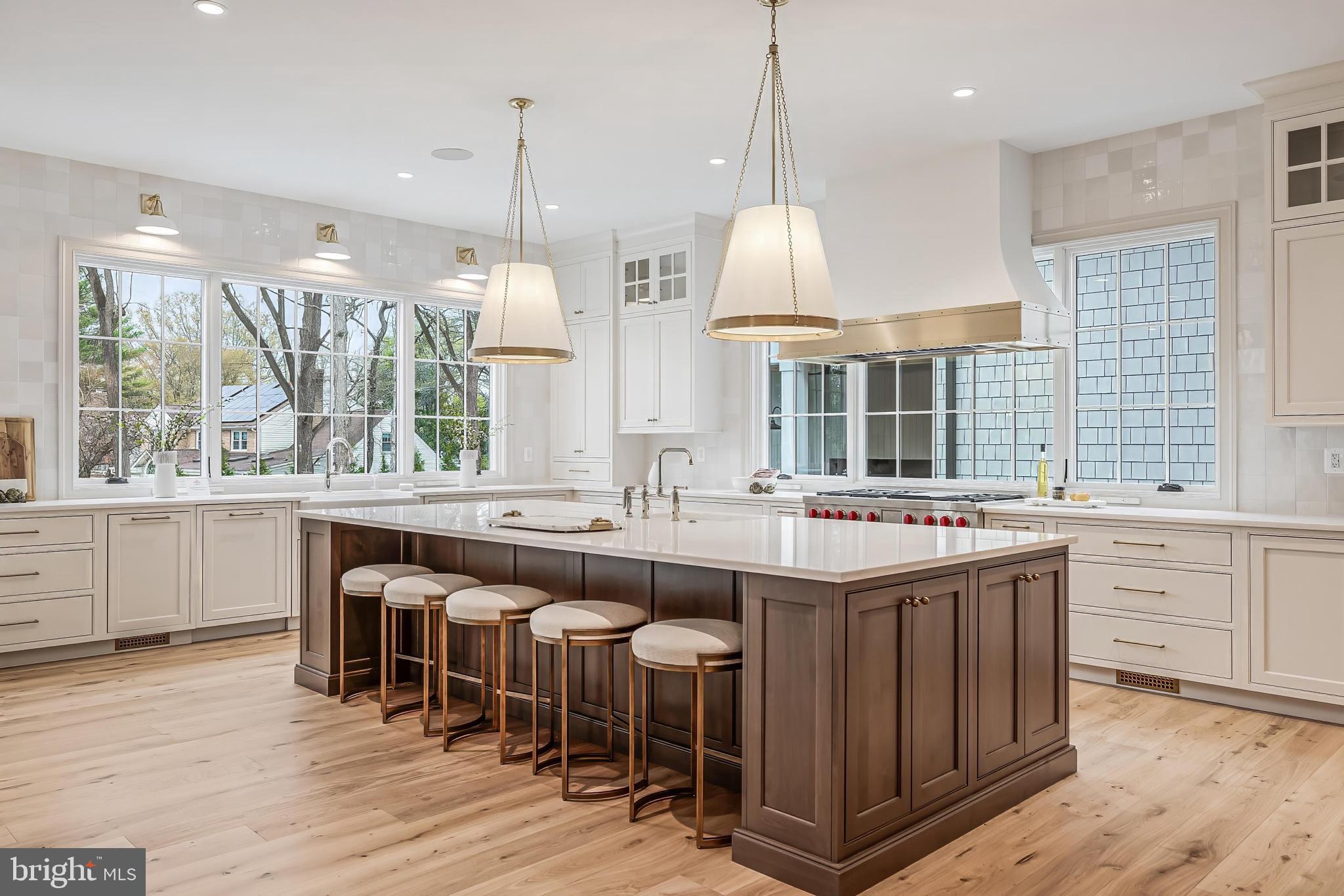 6913 Benjamin Street McLean, VA 22101 - Photo 19 of 51 a kitchen with kitchen island granite countertop a sink and wooden floors
