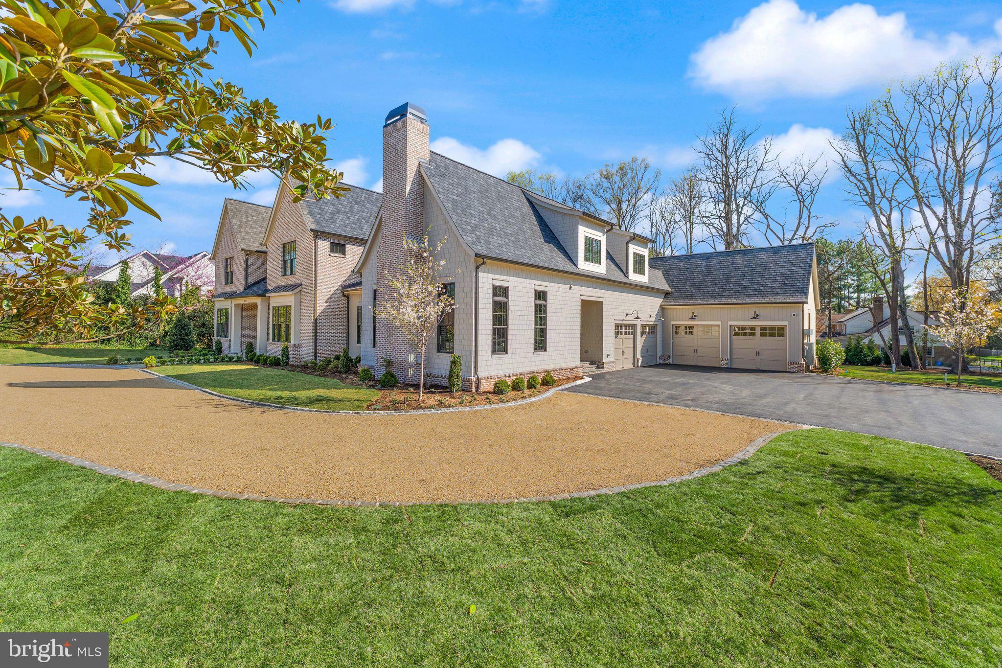 6913 Benjamin Street McLean, VA 22101 - Photo 2 of 51 a front view of a house with a yard and garage