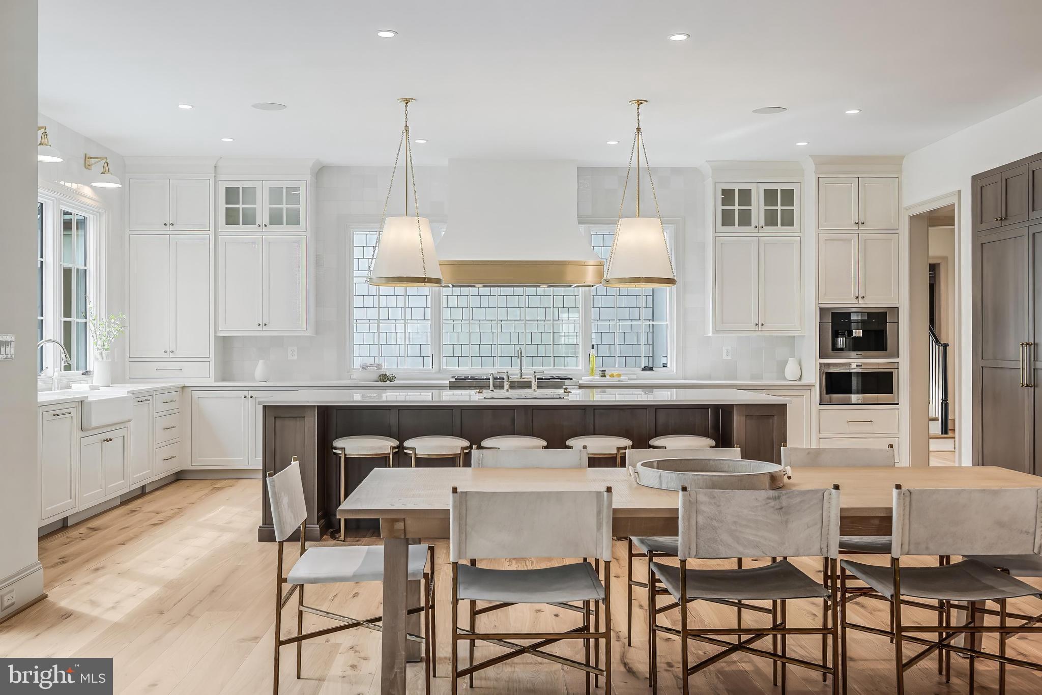 6913 Benjamin Street McLean, VA 22101 - Photo 21 of 51 a kitchen with a table chairs stove and microwave