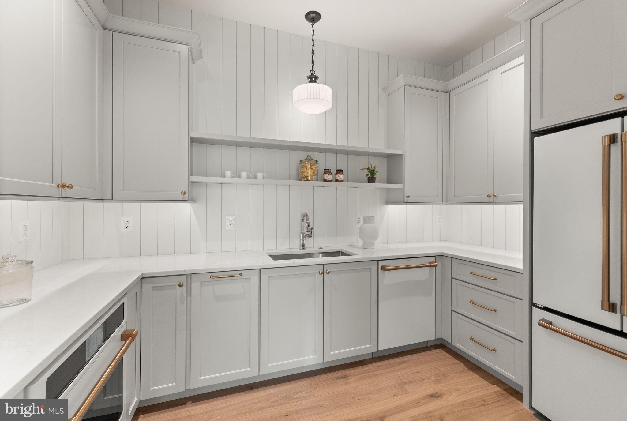 6913 Benjamin Street McLean, VA 22101 - Photo 23 of 51 a kitchen with white cabinets and white appliances