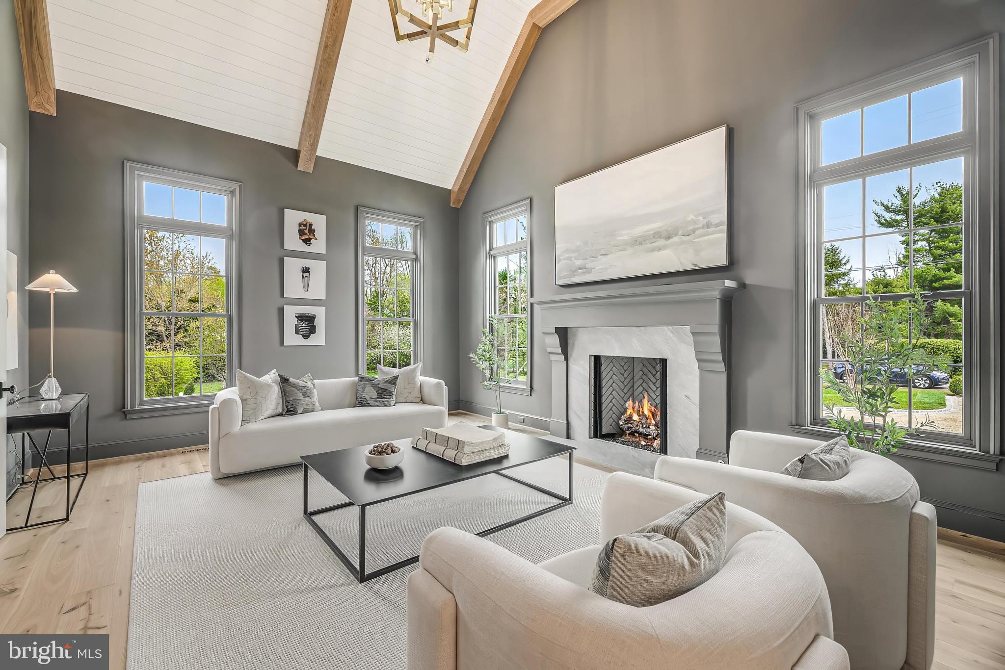 6913 Benjamin Street McLean, VA 22101 - Photo 29 of 51 a living room with furniture a fireplace and a large window