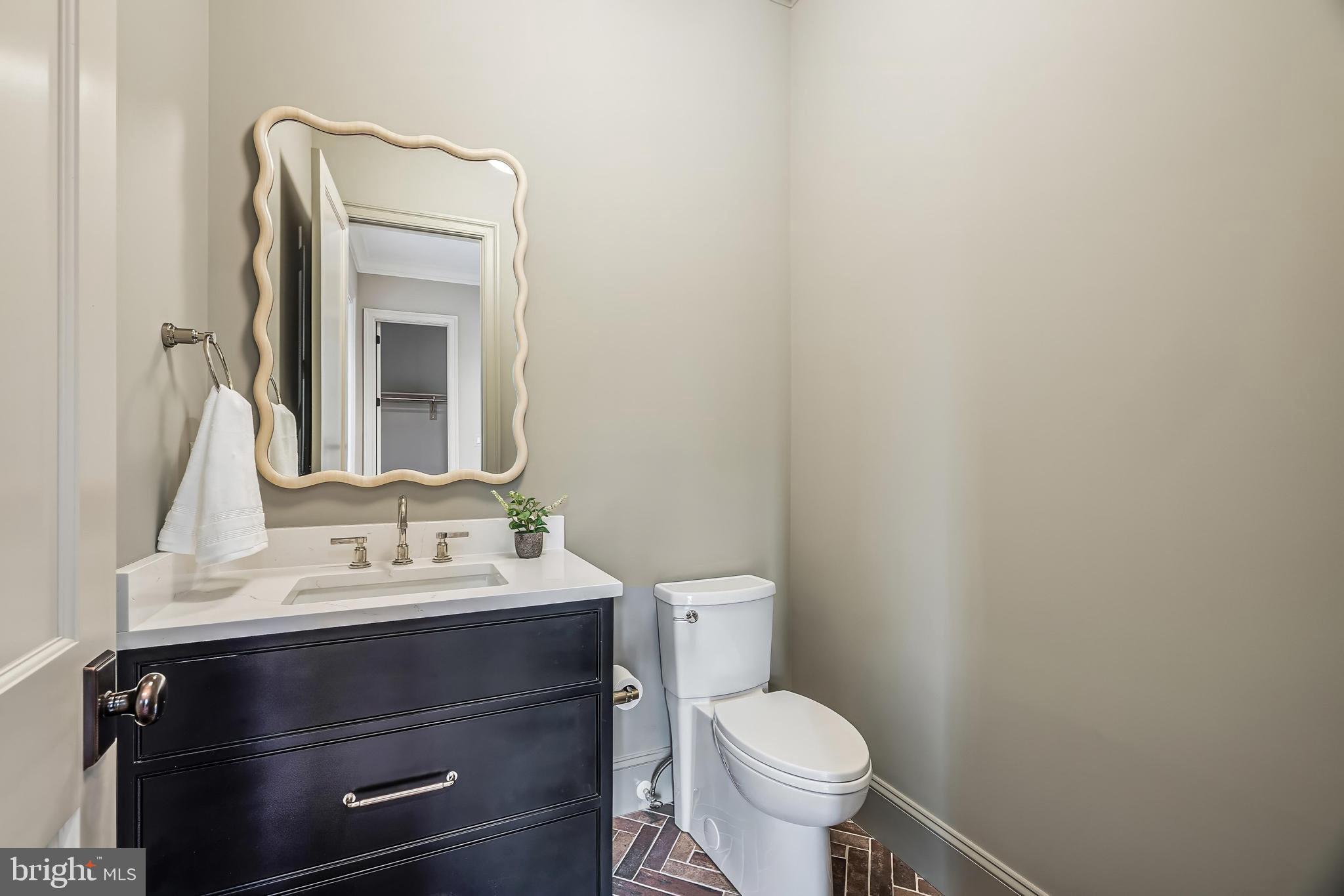 6913 Benjamin Street McLean, VA 22101 - Photo 32 of 51 a bathroom with a sink toilet and mirror