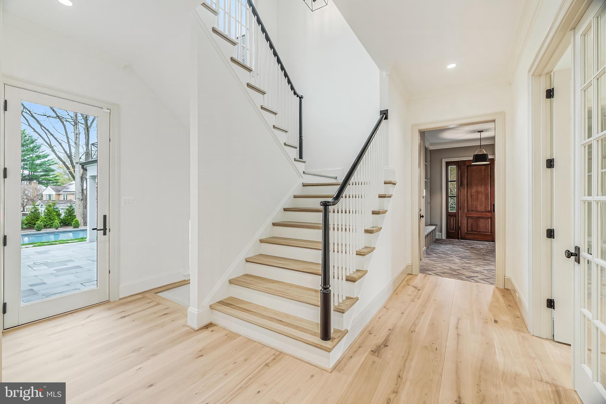 6913 Benjamin Street McLean, VA 22101 - Photo 33 of 51 a view of entryway with wooden floor and stairs