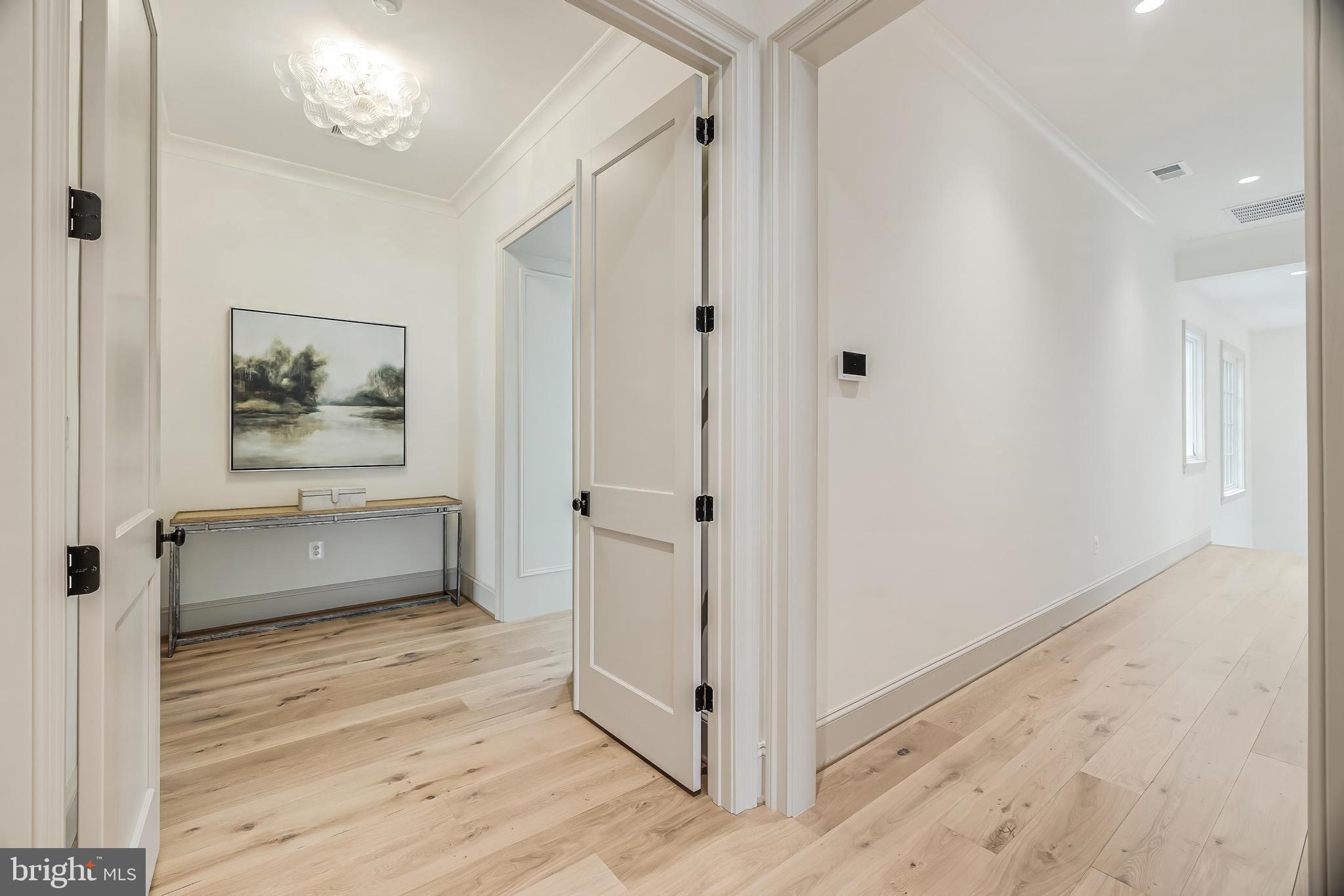 6913 Benjamin Street McLean, VA 22101 - Photo 35 of 51 a view of a hallway with wooden floor and cabinet